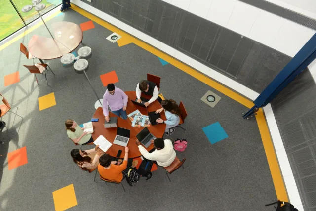 Aerial shot of a group of students at a table in library