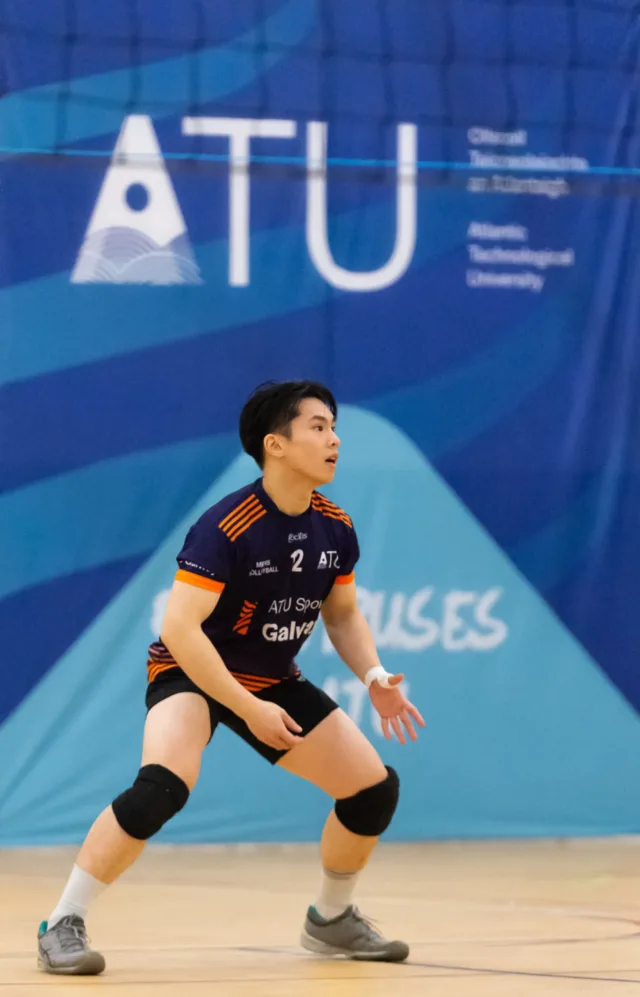 Male student playing volleyball