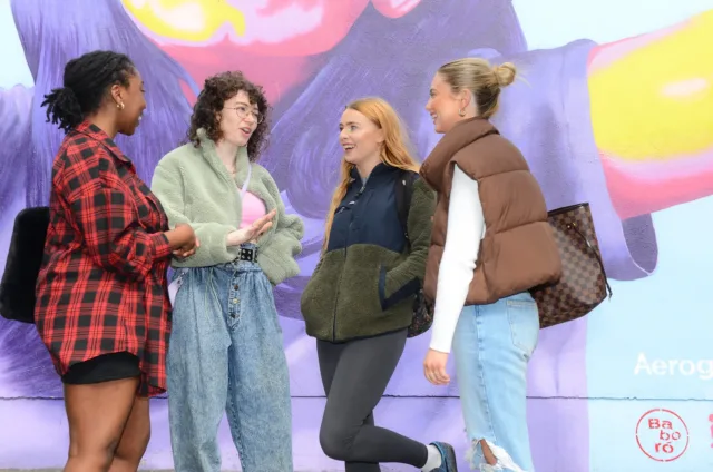 Group of four female students at colourful mural