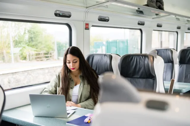 Student with laptop on a train