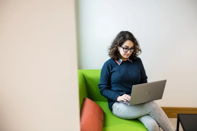 A student studying on a sofa