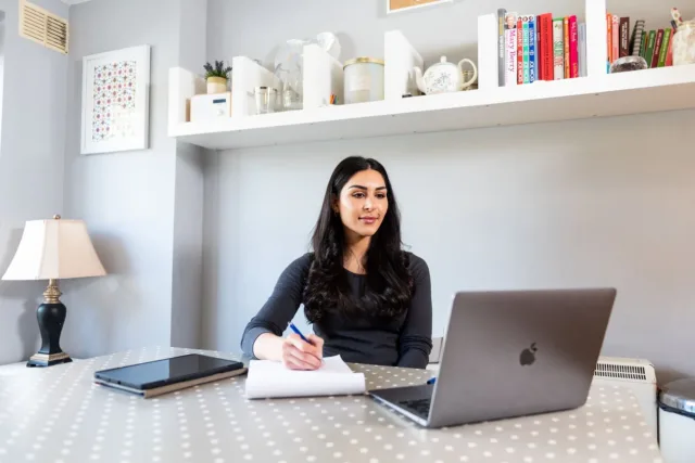 Student taking notes at home