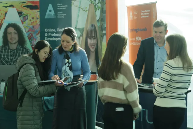 Students speak to lecturers at Postgraduate Information day.