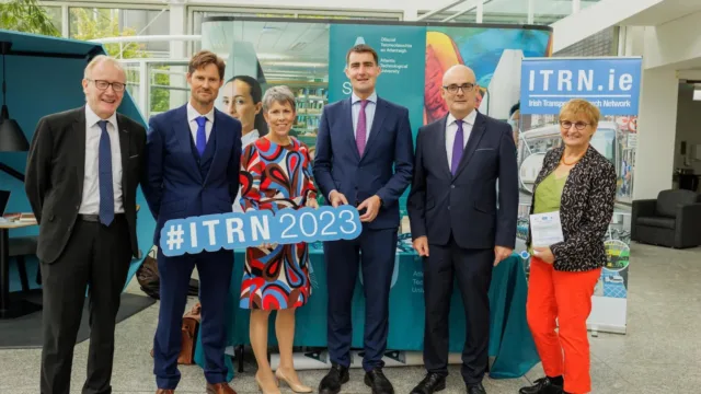 A group of four men and two women smiling for the camera, with ATU President Dr Orla Flynn holding a sign that reads '#ITRN2023