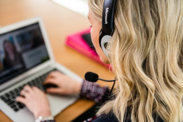 Over the shoulder on an online student, you can see the online class she is attending