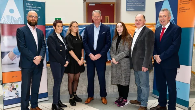 Group photo taken L-R: Stephen O’Reilly, Director of Optum Ireland; Breda Mulgrew, Lecturer and BSc General Nursing Programme Lead at ATU Donegal; Mia Baikie, General Nursing Scholar; Paul Phelan, Senior Director & Site Lead at Optum Ireland (Letterkenny); Catherine Whiteside, Applied Computing Scholar; Thomas Dowling, Head of Computing at ATU Donegal; and Paul Hannigan, Head of College at ATU Donegal, all smiling for the camera.