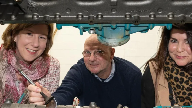 Shirley McConalogue, Richard Timoney, and Helen Kelly at the Killybegs Marine Cluster event, hosted by ATU. They are pictured between some engineering equipment at the event in Killybegs.