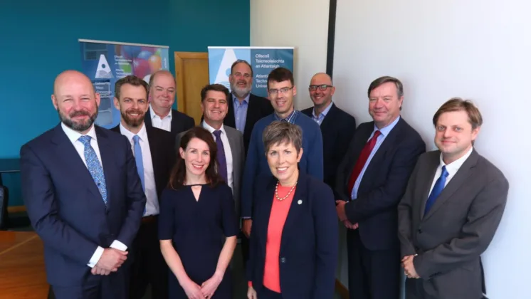 A group of academic leaders and researchers smile for a photo, including Prof Philip Nolan (SFI), Dr Eoin Furey (PRTP Lead Supervisor), Chris O'Malley (ATU Sligo), Dr Marion McAfee, Dr Rick Officer (VP Research & Innovation, ATU Galway Mayo), Prof Graham Heaslip (ATU Galway Mayo), Dr Liam Morris, Dr Orla Flynn (President, ATU), Dr George Onofrei, Dr John Bartlett, and Dr Eoin Cullina (Head of Research, ATU Galway Mayo).