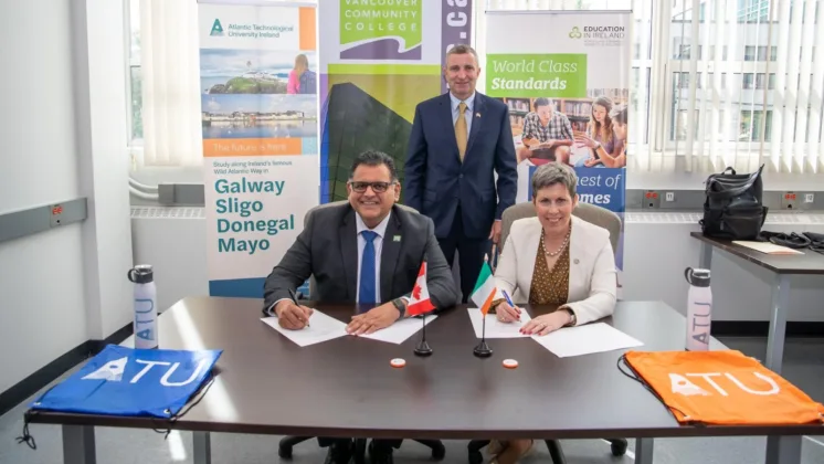 ATU President Dr. Orla Flynn signing agreements in the presence of Minister for State for Further and Higher Education, Research, Innovation and Science, Mr. Niall Collins TD, and Consul General at the Irish Consulate in Vancouver, Mr. Frank Flood.