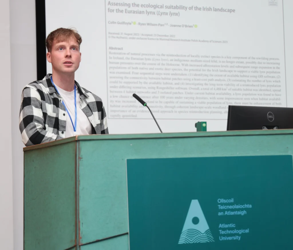 man speaking on podium at All Ireland Mammal symposium