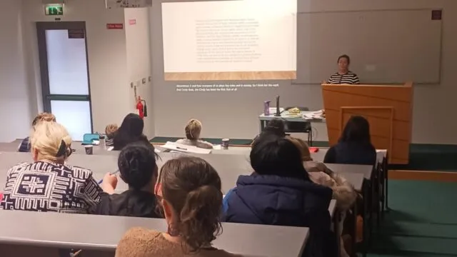 Woman gives presentation to audience