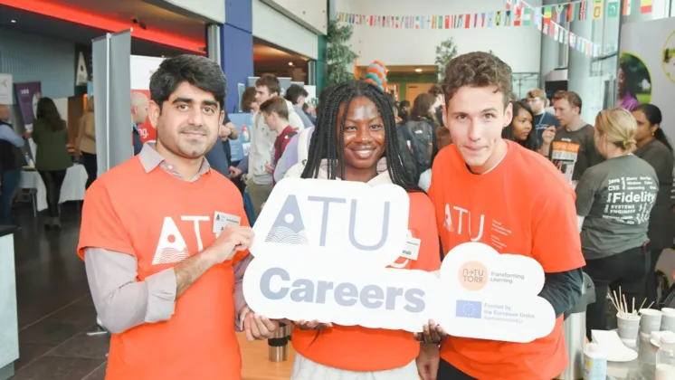 3 students hold ATU careers fair sign