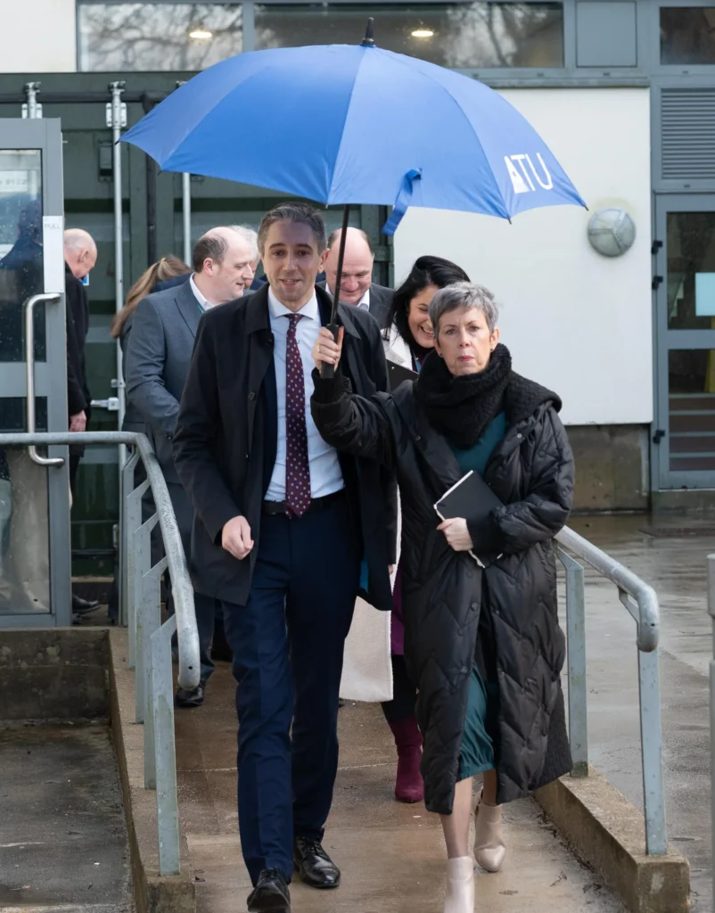 Minister Harris and ATU president Orla Flynn under umbrella