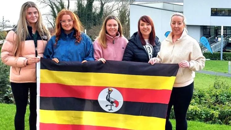 Irish nursing students holding Uganda flag