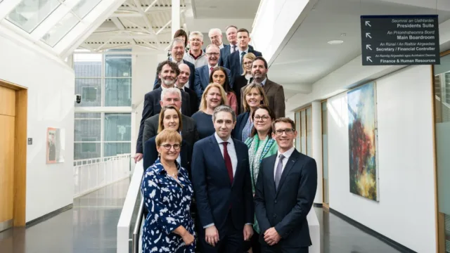 Minister for Further and Higher Education, Research, Innovation and Science, Simon Harris TD, stands alongside ATU colleagues for a photo on the staircase at the ATU Sligo campus.