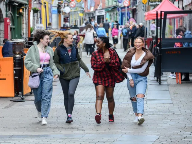 Four people walking on the street