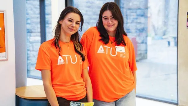 2 female ATU Students in orange ATU t-shirts