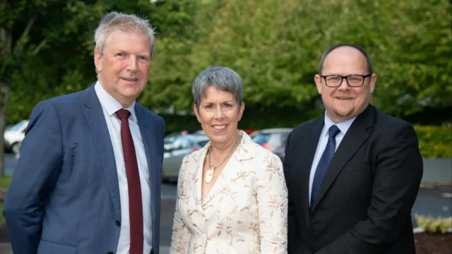 Three people smiling for the camera, standing together. One is a professor in research, another is the president of ATU, and the third is the CEO of Tyndall.