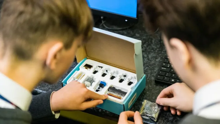 two secondary school students testing equipment