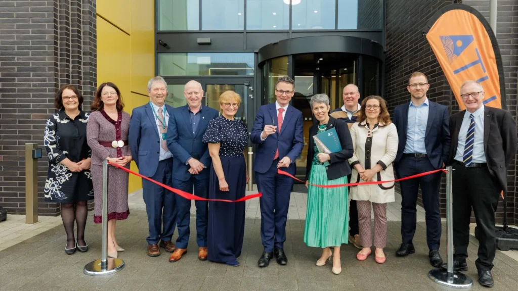 minister for further education cutting reed ribbon with ATU staff