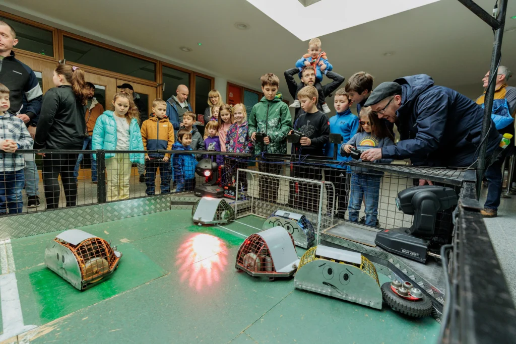 Children and parents watch robots