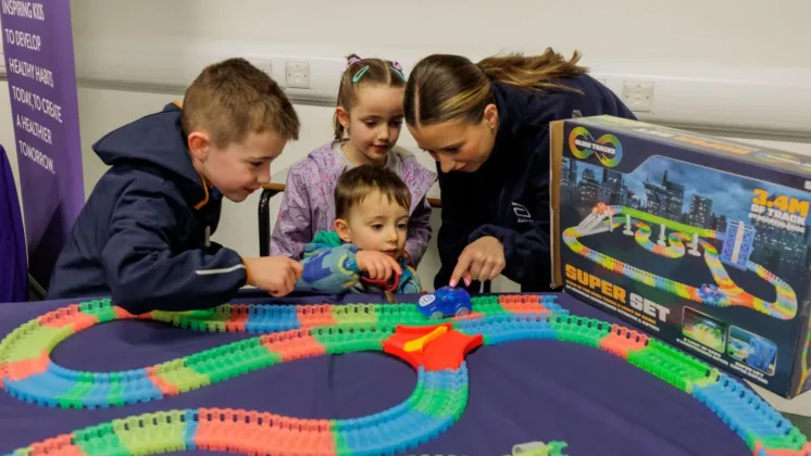 Children playing with car and race track