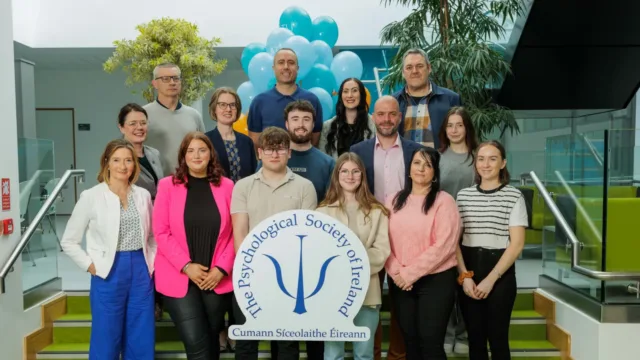 group poses with Psychological Society of Ireland sign