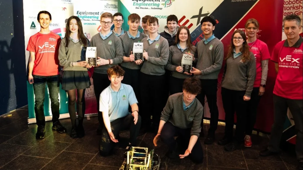 Secondary school students holding awards