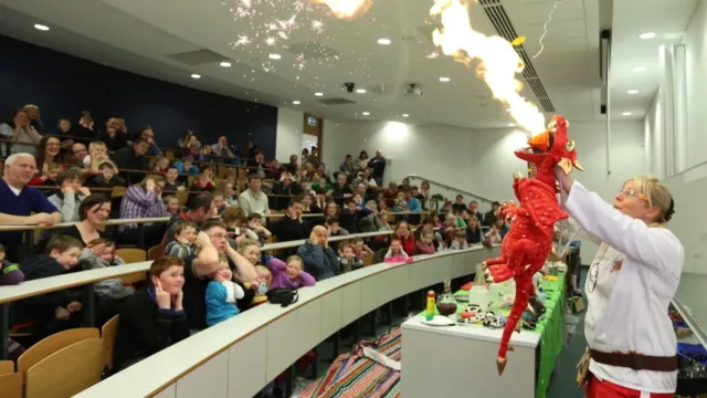 dragon breathing fire demonstration to school children for science festival