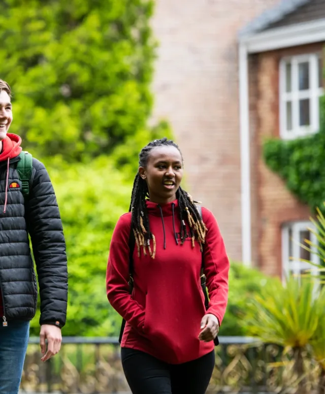 Two students walking out of their student accommodation complex