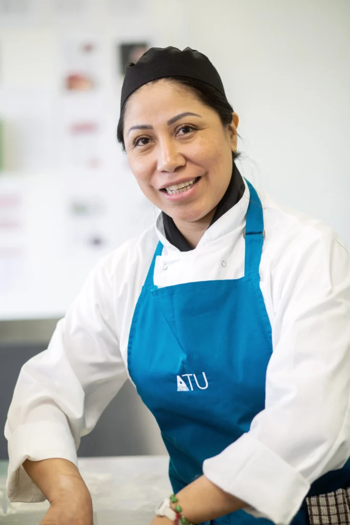 Female international student in her culinary uniform working in kitchens in Killybegs