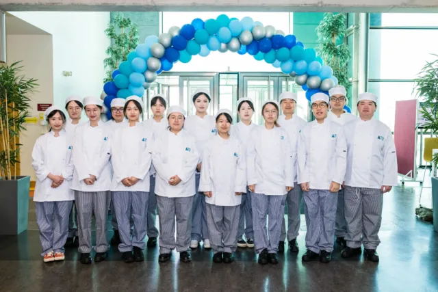 A group of international student in their culinary uniforms for the Galway International Hotel School