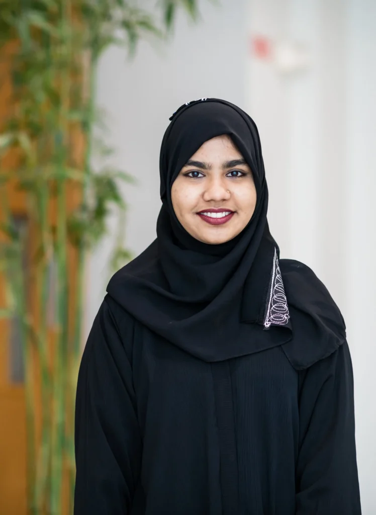 Female international student stand in hallway in black hijab