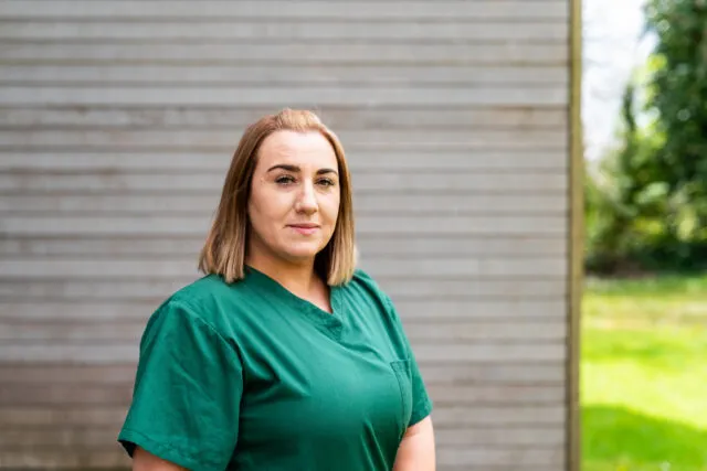 Nursing student in green scrubs in the outdoors